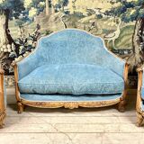 Art deco living room around 1920 in carved wood upholstered in blue velvet, a sofa two armchairs