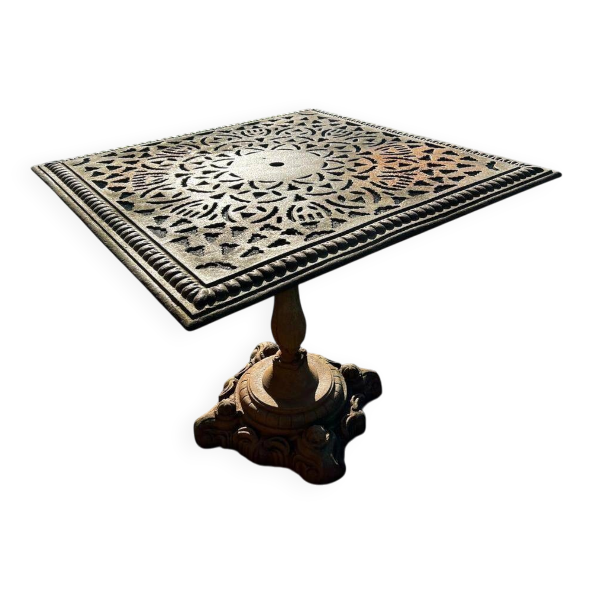 Antique cast iron garden table with decorative openwork top.