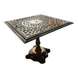 Antique cast iron garden table with decorative openwork top.