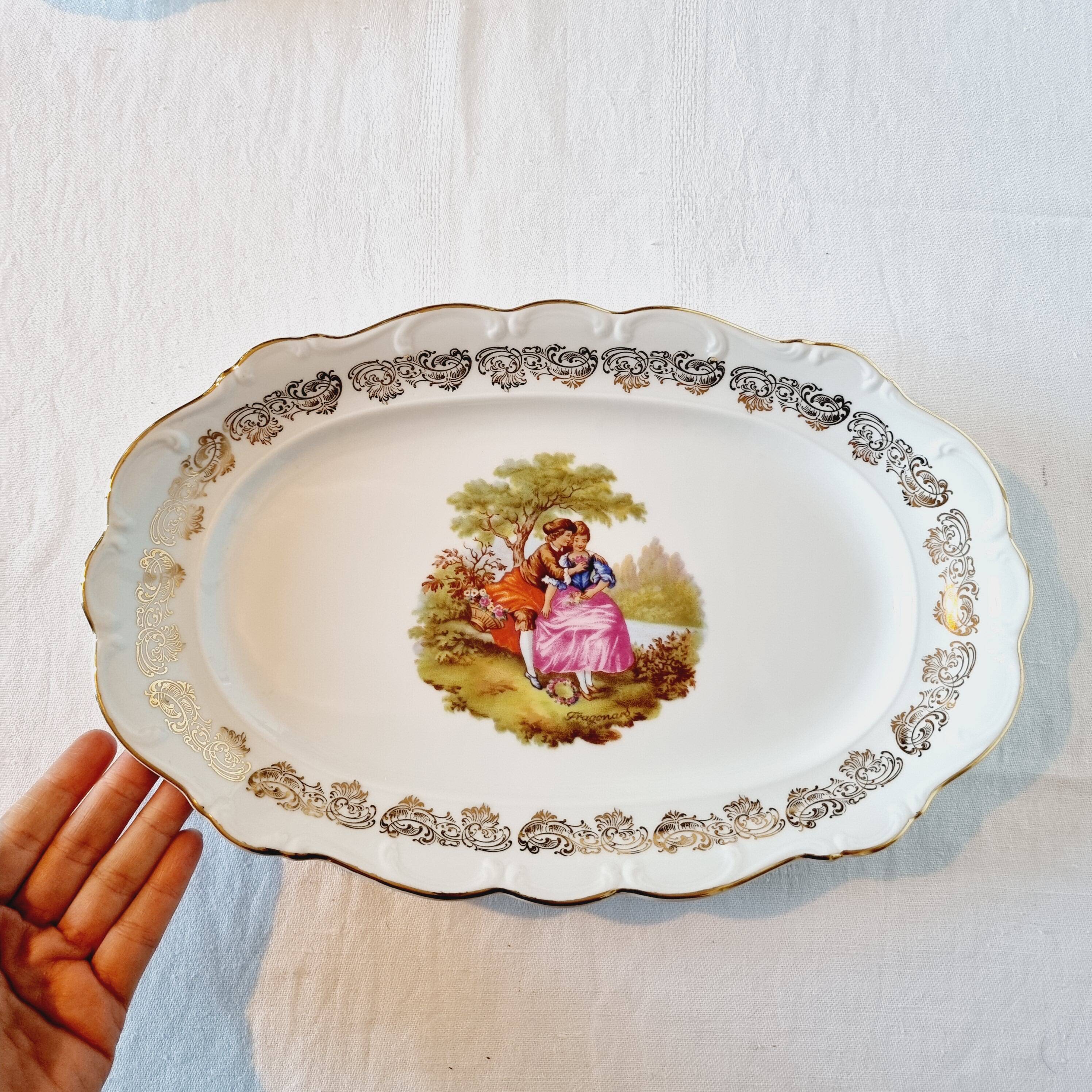 3 serving dishes with frangonard romantic scene with designs and borders in 24 carat gold.