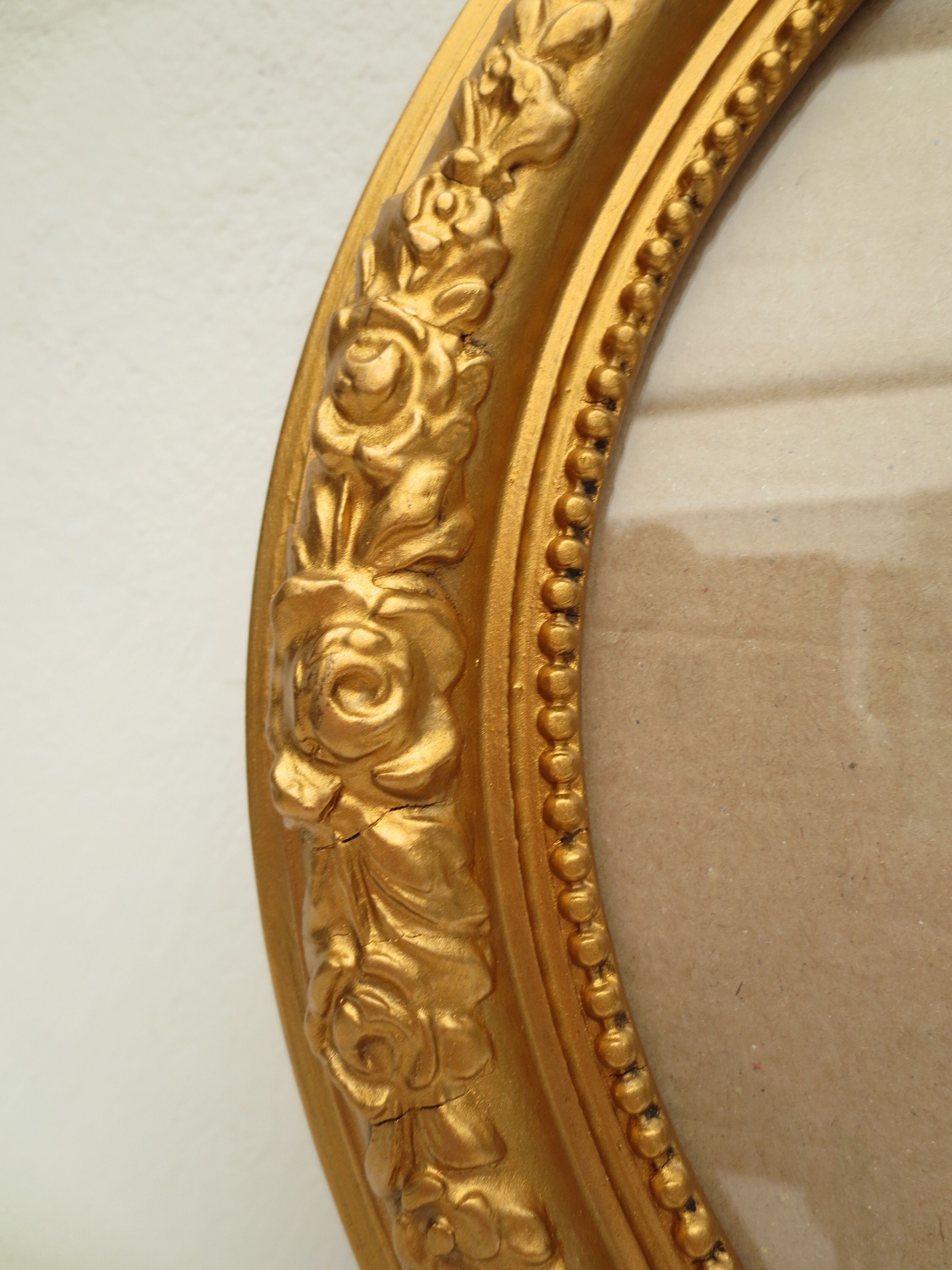 Large old oval gilded wooden frame and stucco decorations
