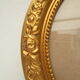 Large old oval gilded wooden frame and stucco decorations