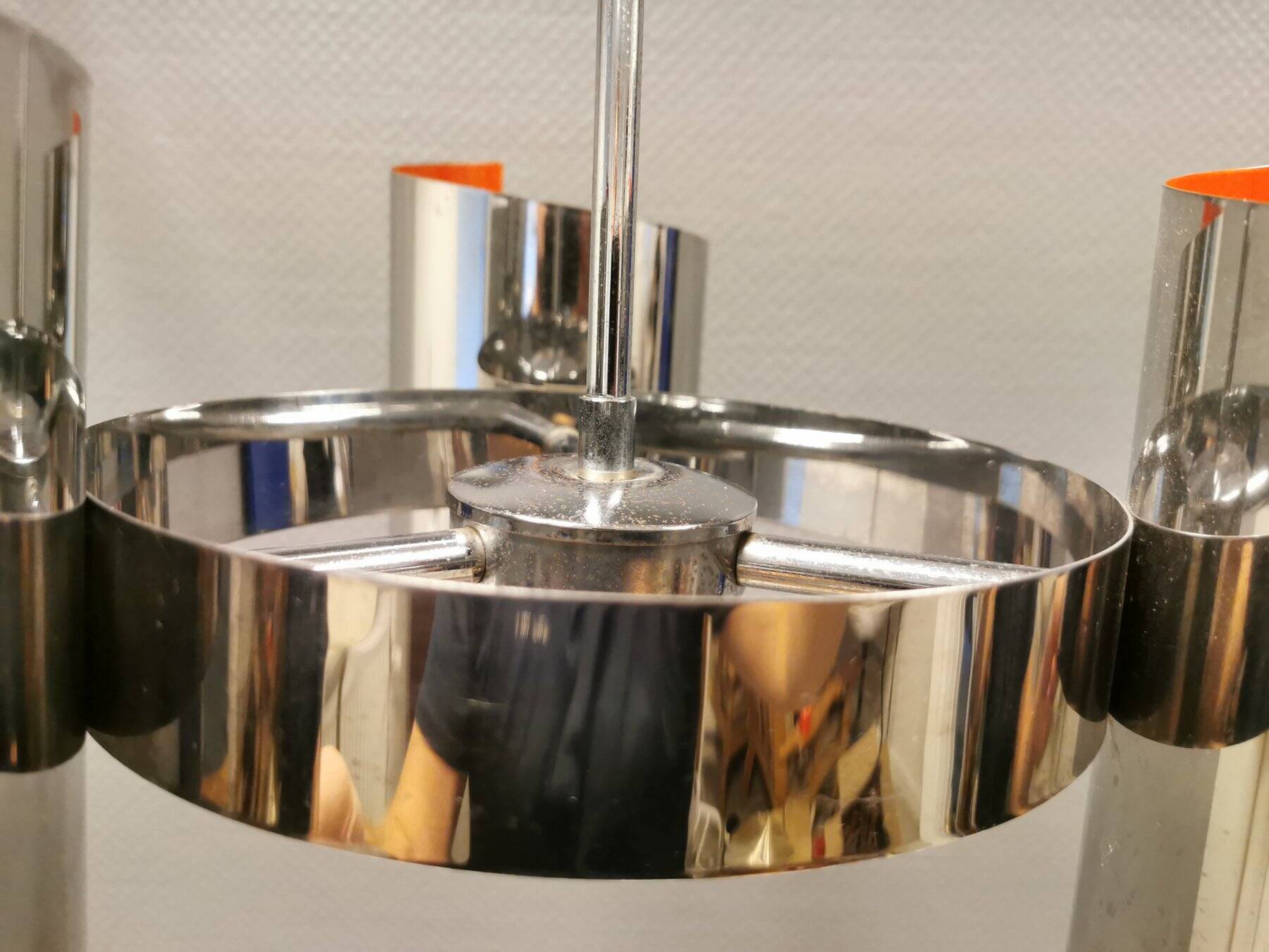 Hanging lamp in chromed metal with orange contrast lacquer and three light sources.