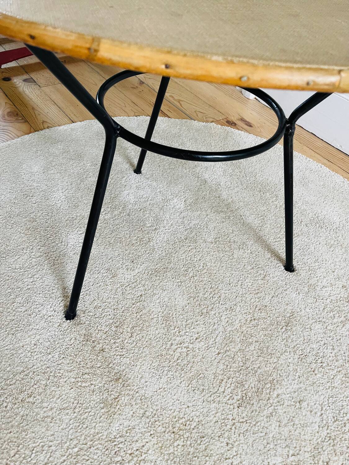 Tripod coffee table with a straw covering.