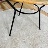 Tripod coffee table with a straw covering.