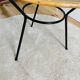 Tripod coffee table with a straw covering.