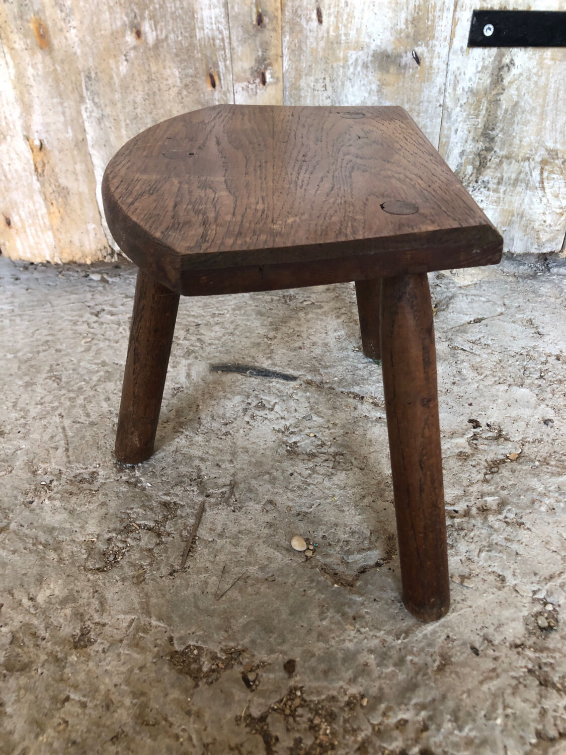 Old vintage wooden tripod milking stool