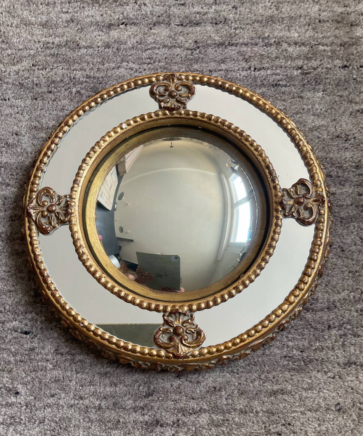 Antique domed witch's eye mirror in gilded wood