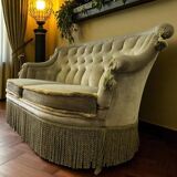 Vintage green two-seater sofa with fringes