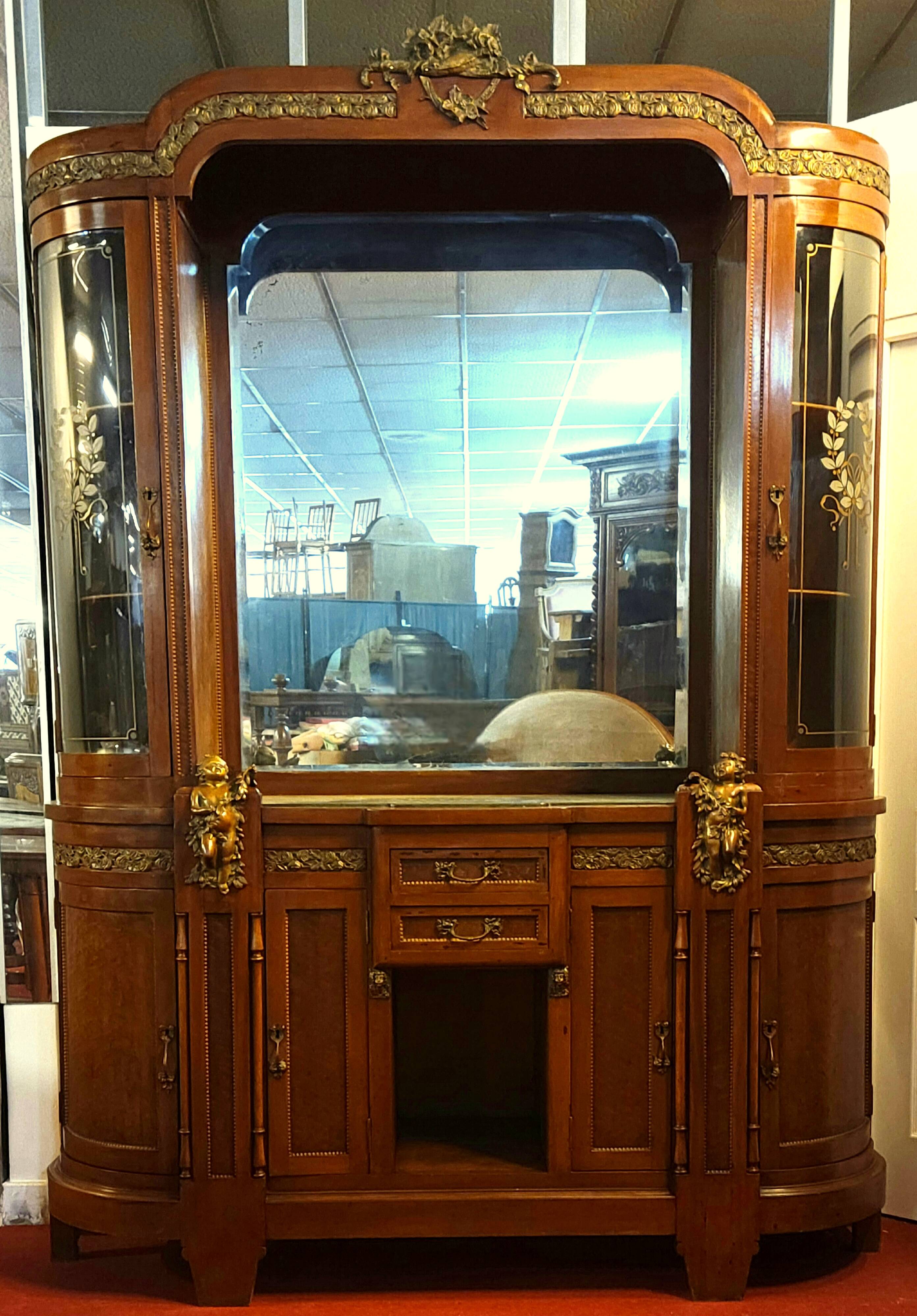 Empire style half-moon shaped mahogany bookcase with putti