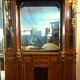 Empire style half-moon shaped mahogany bookcase with putti