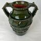 Terracotta jar with dark green handles