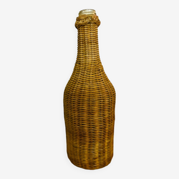 Old glass and rattan wicker bottle