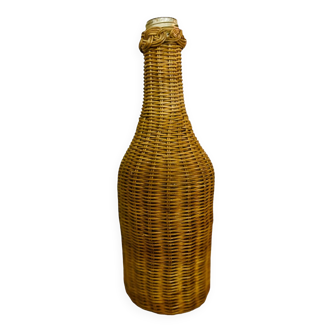 Old glass and rattan wicker bottle