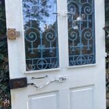 Entrance door in solid oak, cast iron grille, 1930s