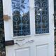 Entrance door in solid oak, cast iron grille, 1930s