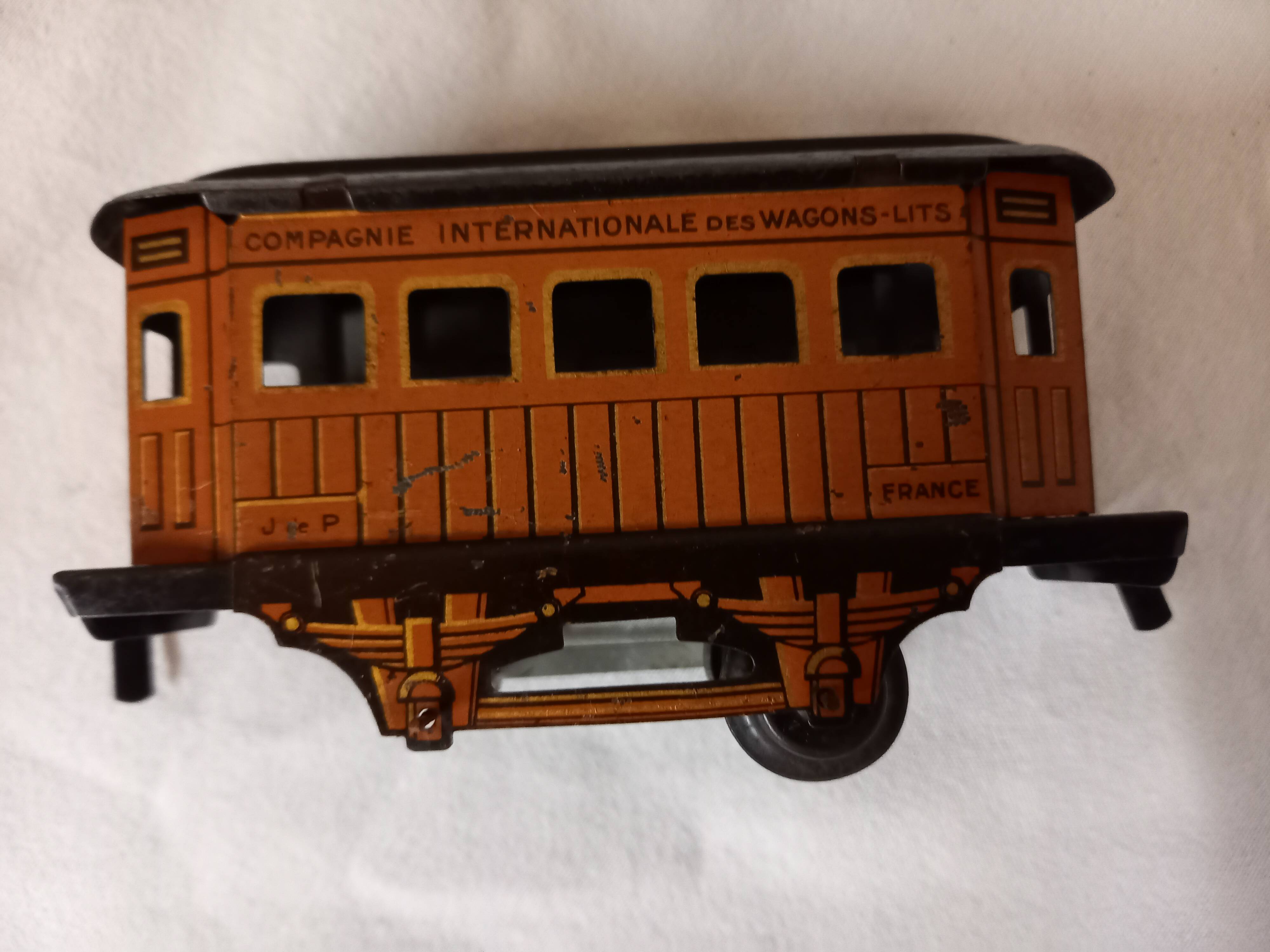 Small JEP mechanical train, including locomotive, tender, sleeping car, rail, 1930s