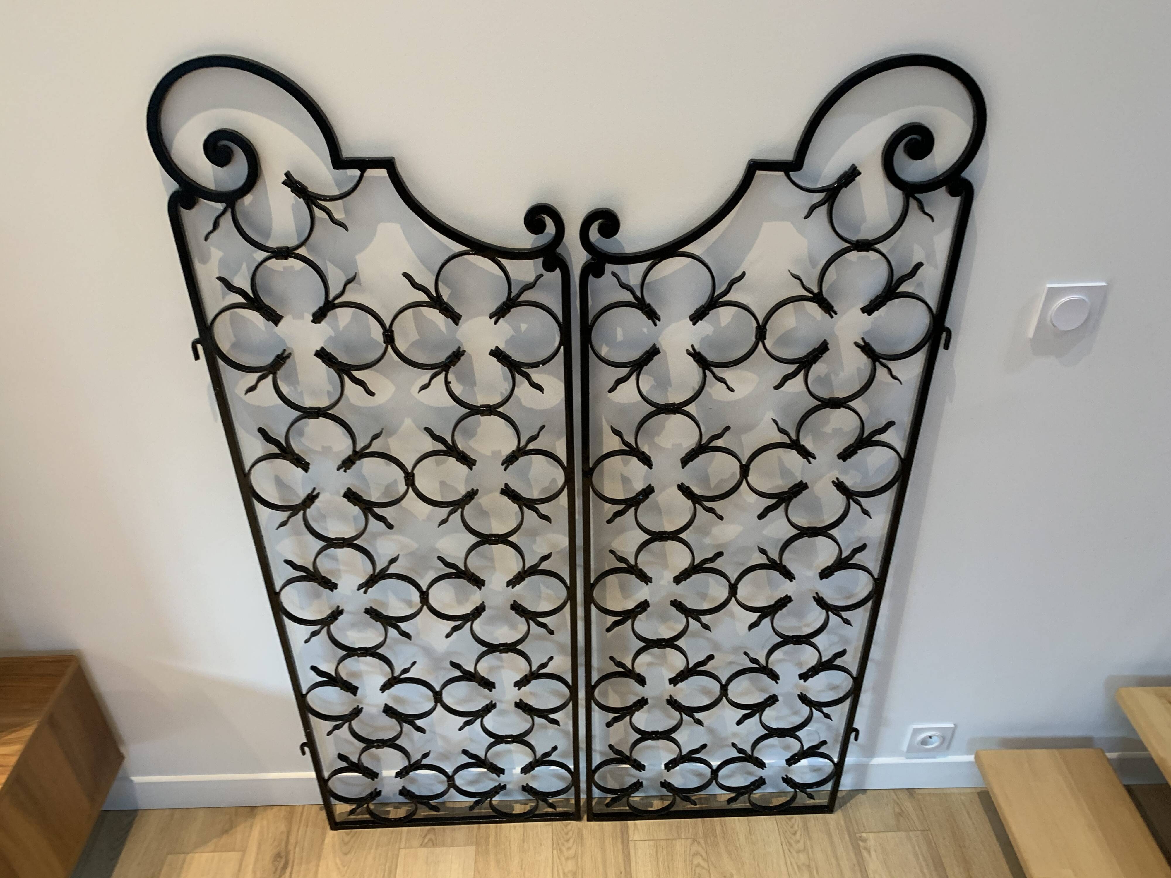 Ancient pair of door opening gates has hell volutes forged craftsmanship