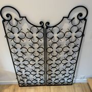 Ancient pair of door opening gates has hell volutes forged craftsmanship