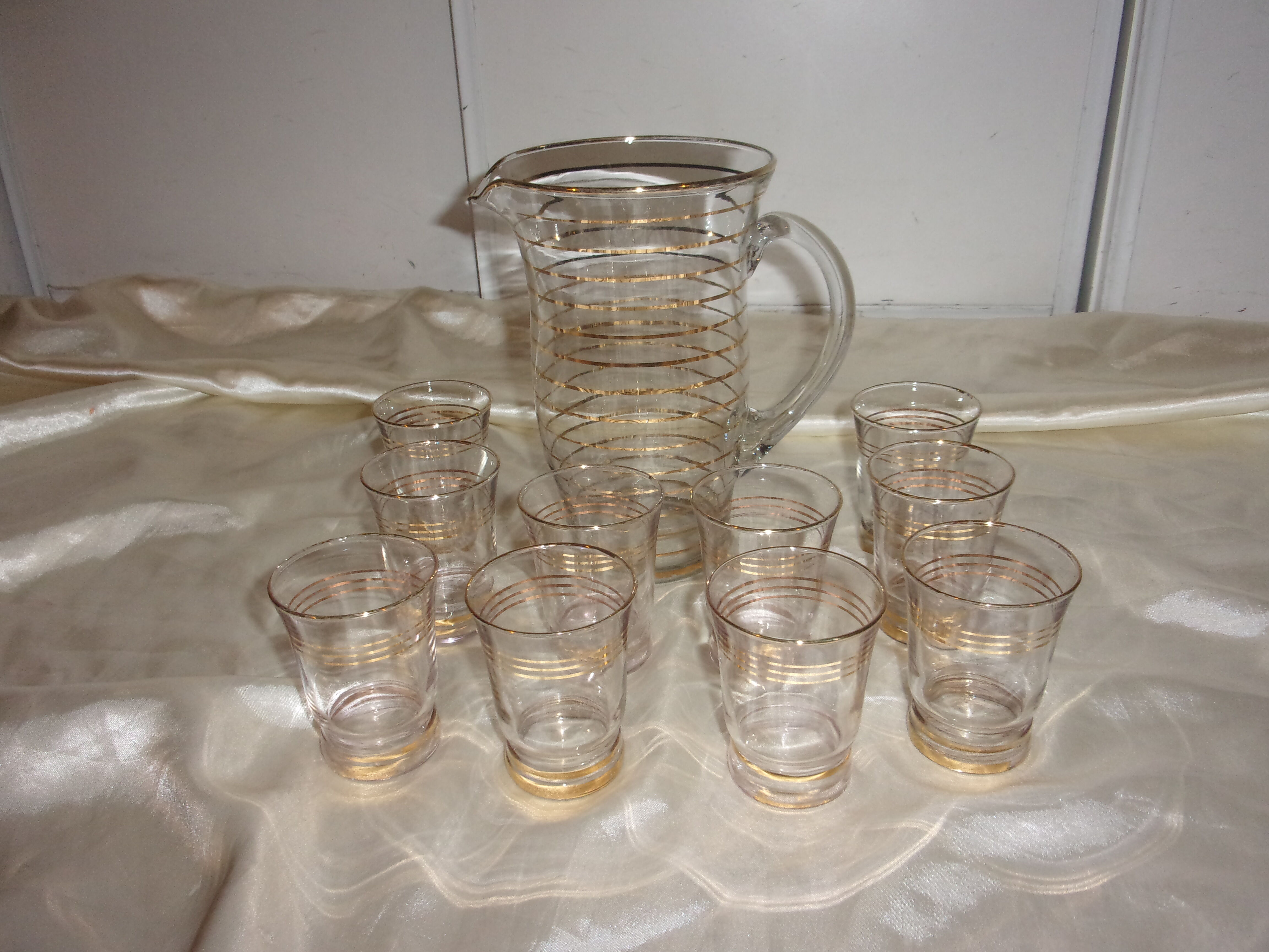 Service in glass pitcher and 10 glasses