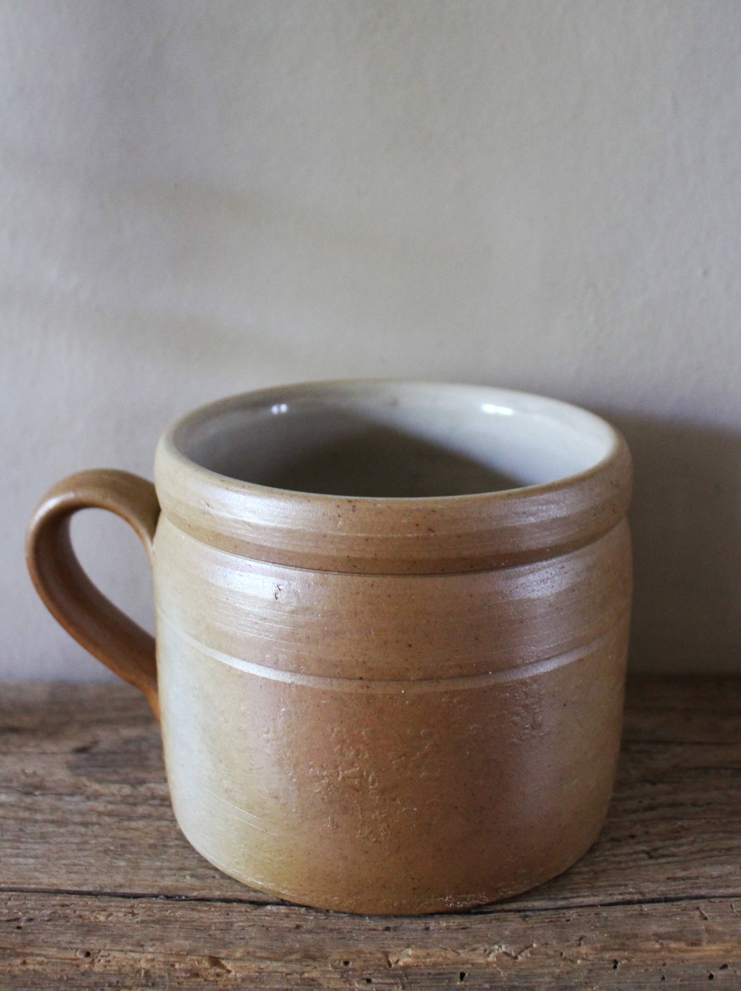 Vase terracotta milk jug with a glazed interior handle.