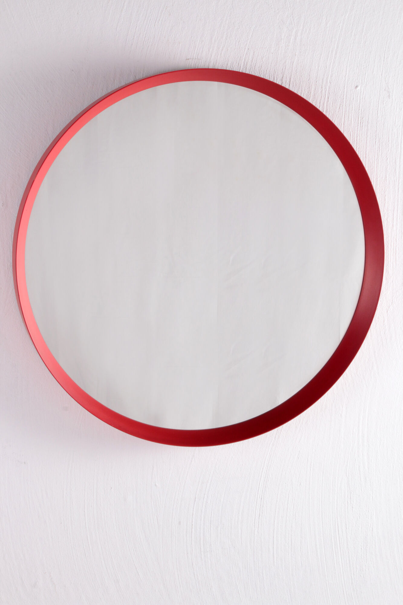 Vintage red round plastic mirror from the 1960s.