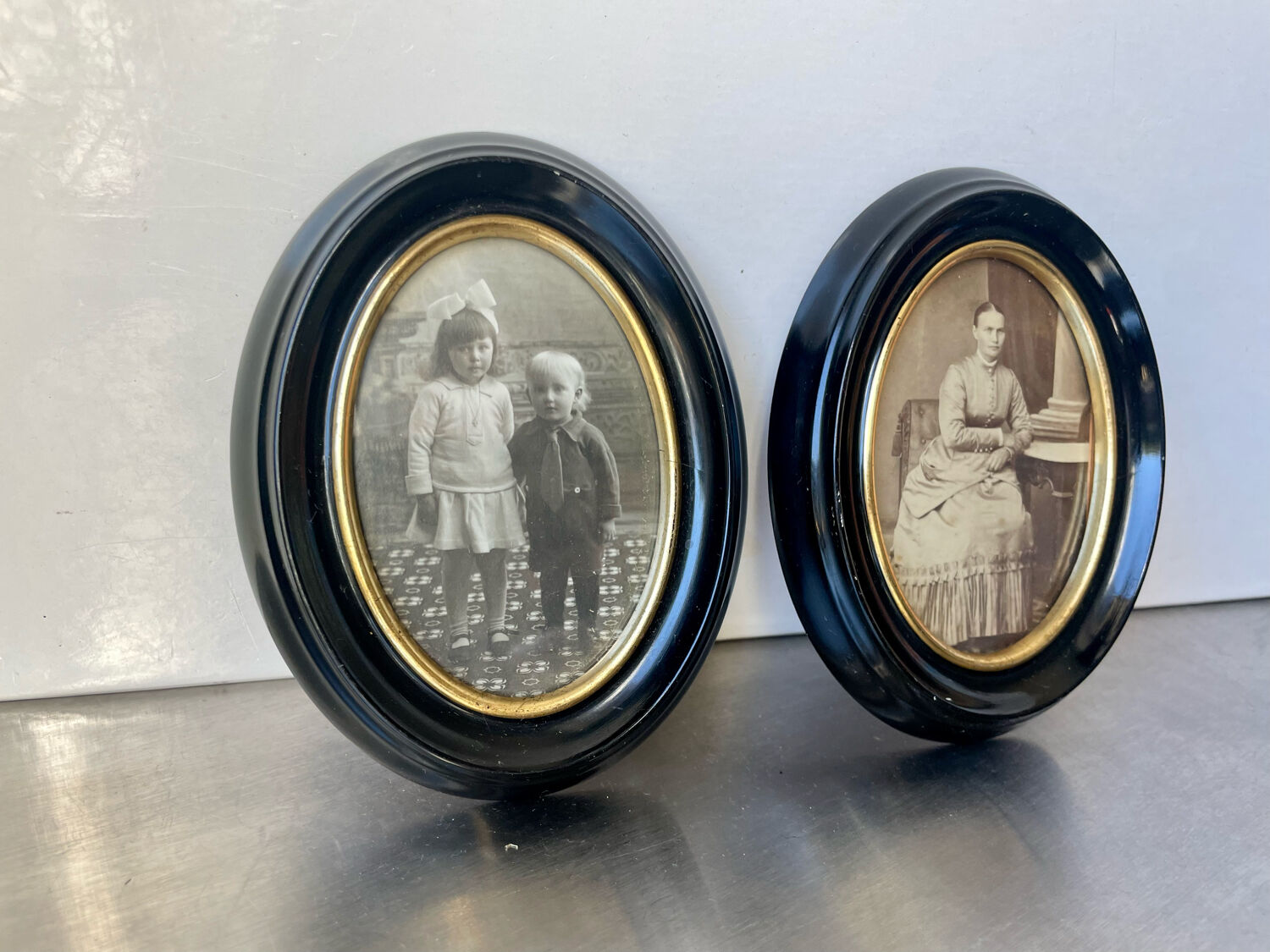 Pair of black wooden oval frames 1880’s  each 13 cm x 10 cm glass measurements 8.5 cm x 5.5 cm