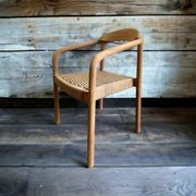 solid wood chair with woven seat and armrests