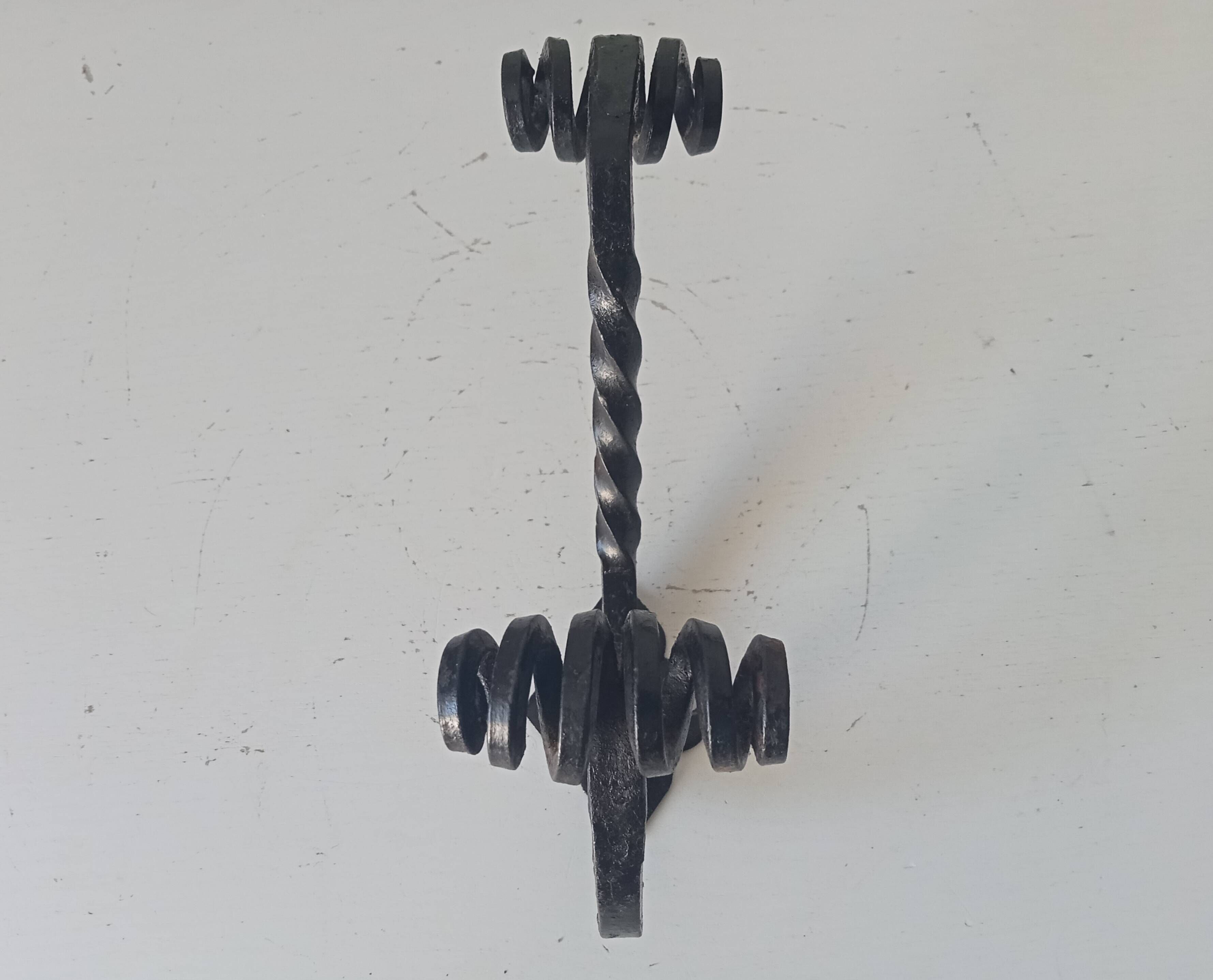 Brutalist wall coat rack in wrought iron.
