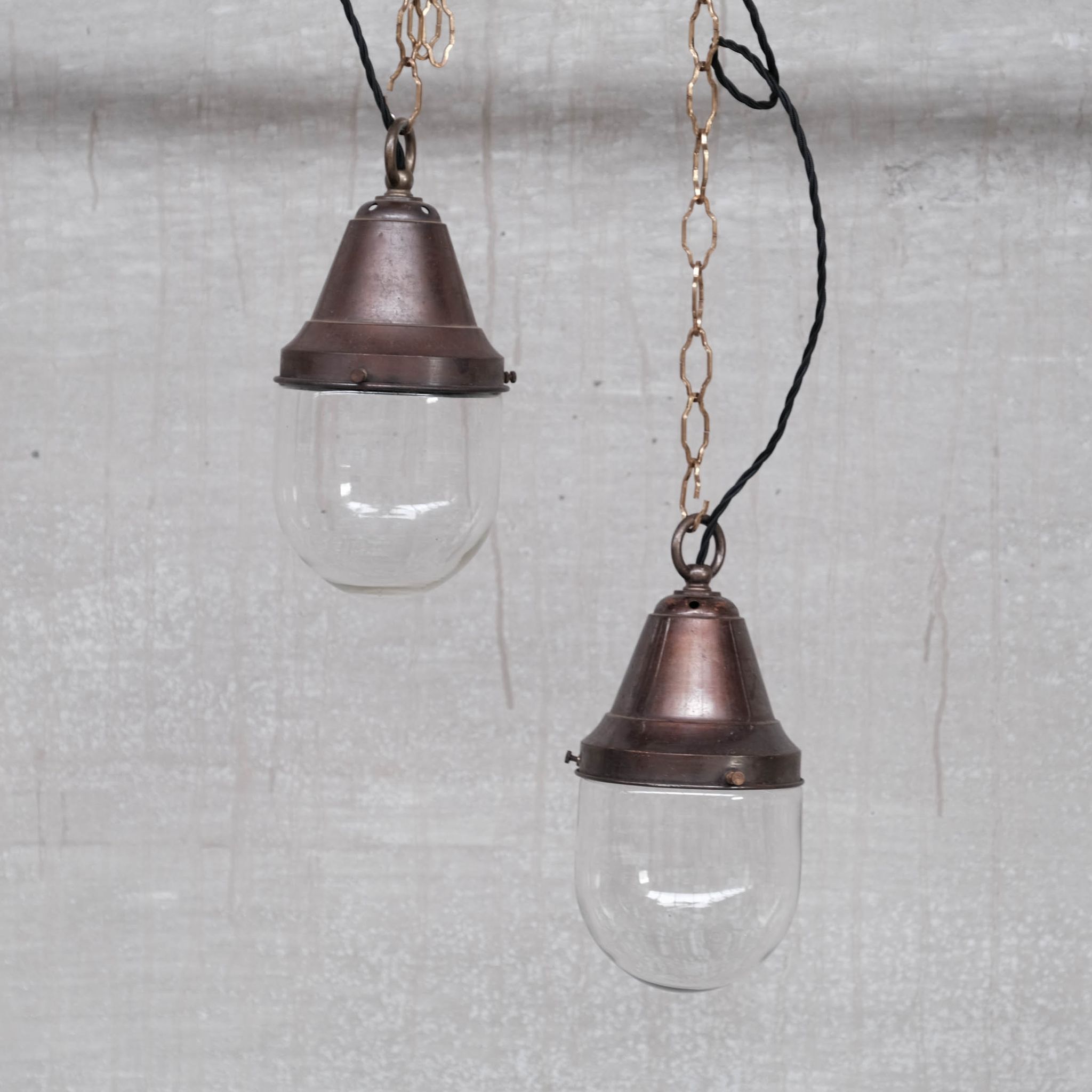 Pair of brass and clear glass industrial pendants