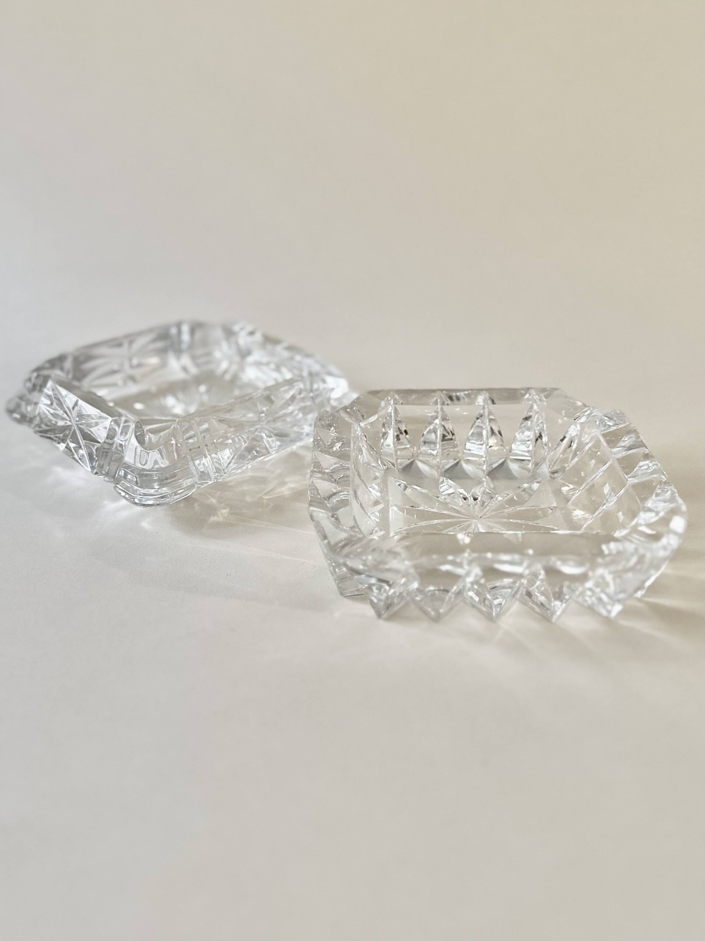 A pair of crystal ashtrays.