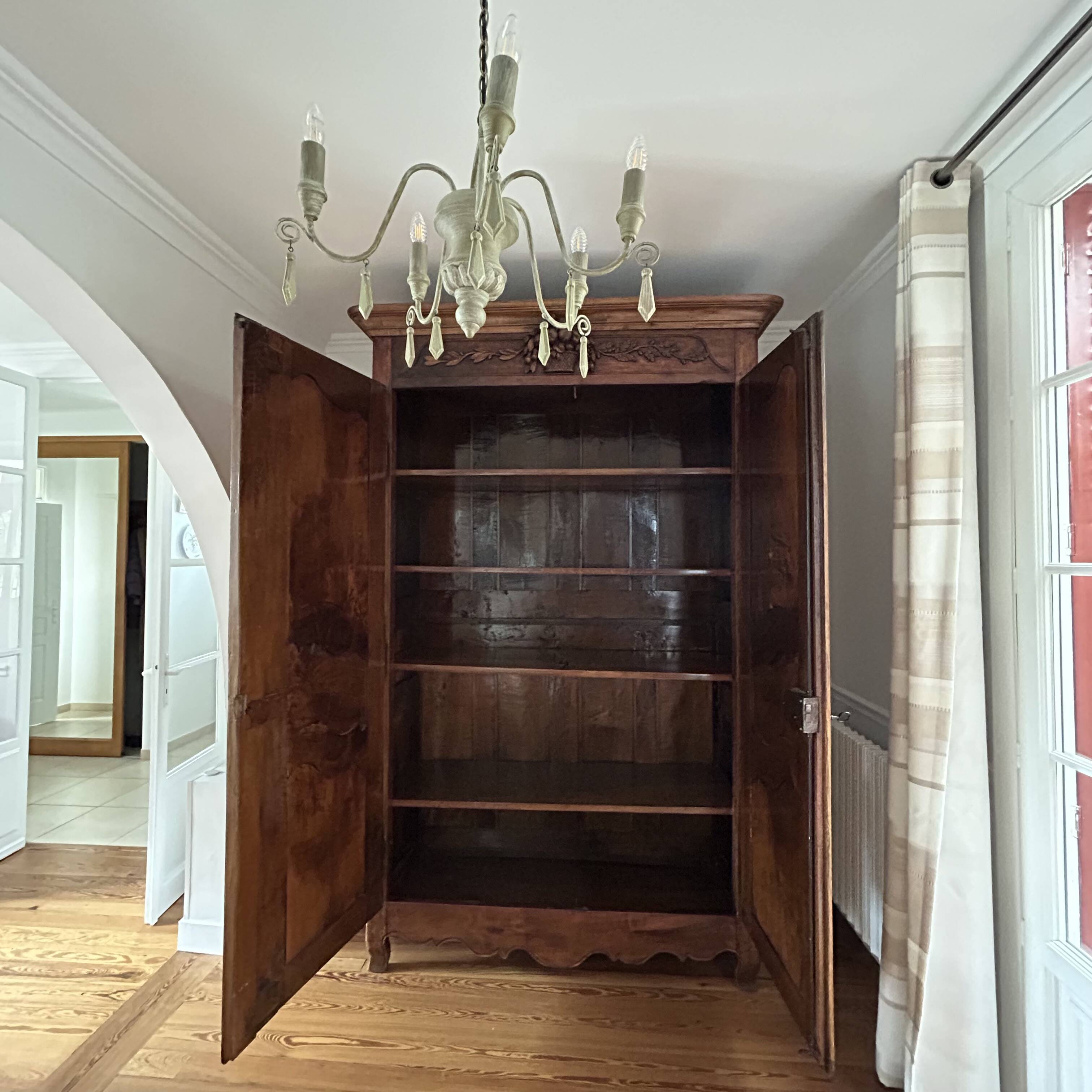 Antique walnut armoire with two doors.