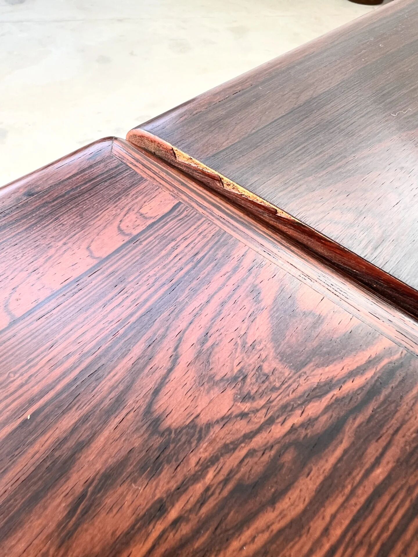 Rosewood dining table with integrated extensions — Denmark, 1960s