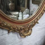 Golden oval mirror
