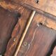 Vintage brown pine dresser with a painted top, moulded panels, and decorative locks.