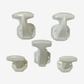 Five art deco white porcelain hooks