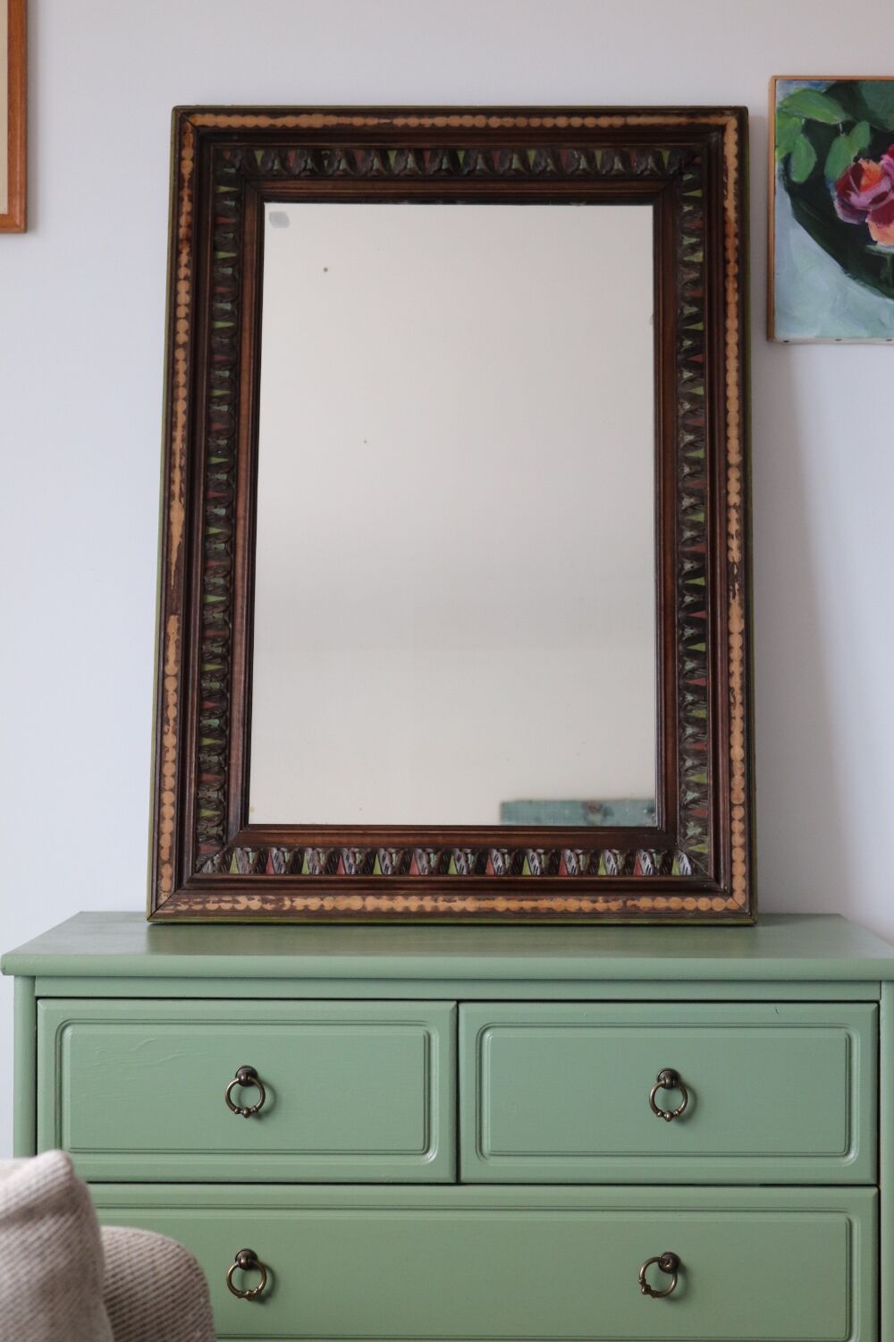 Antique mirror with a carved and painted wooden frame
