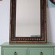 Antique mirror with a carved and painted wooden frame