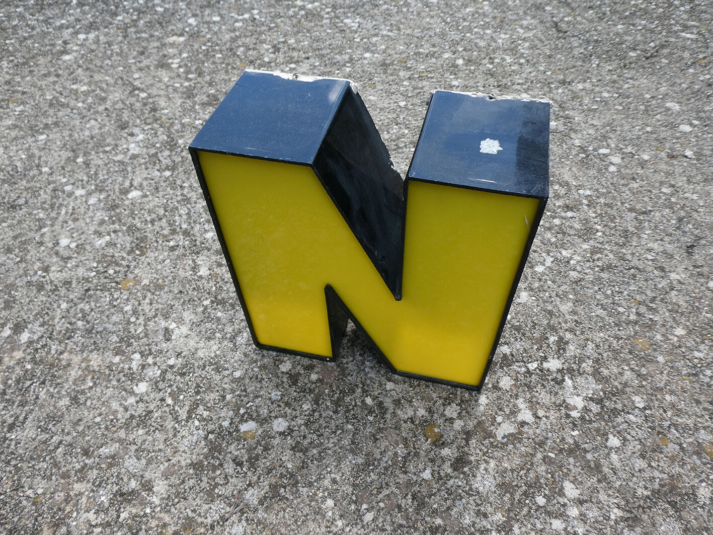 Yellow and black industrial sign letter "N"