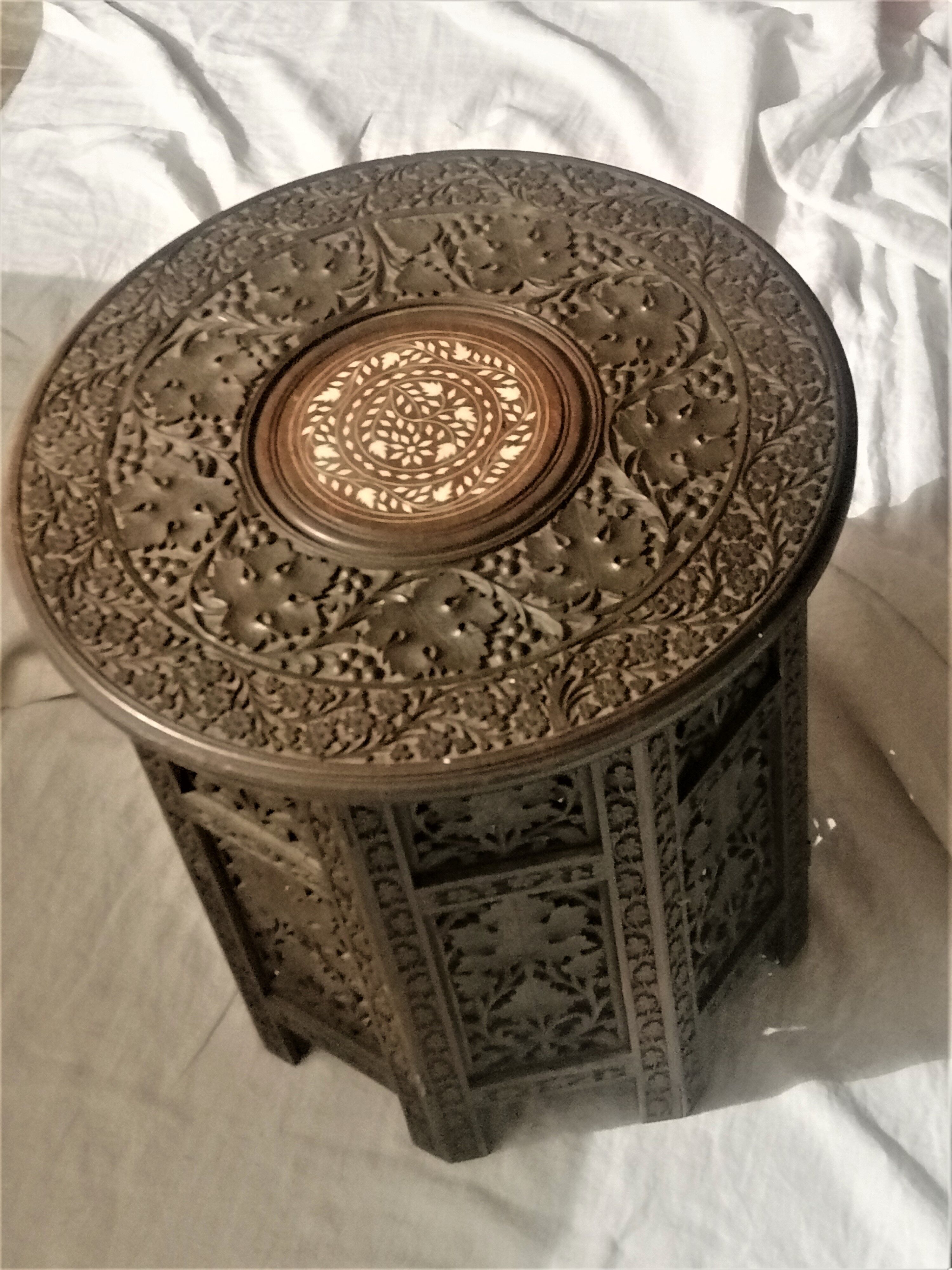 Ancient oriental pedestal table in carved wood