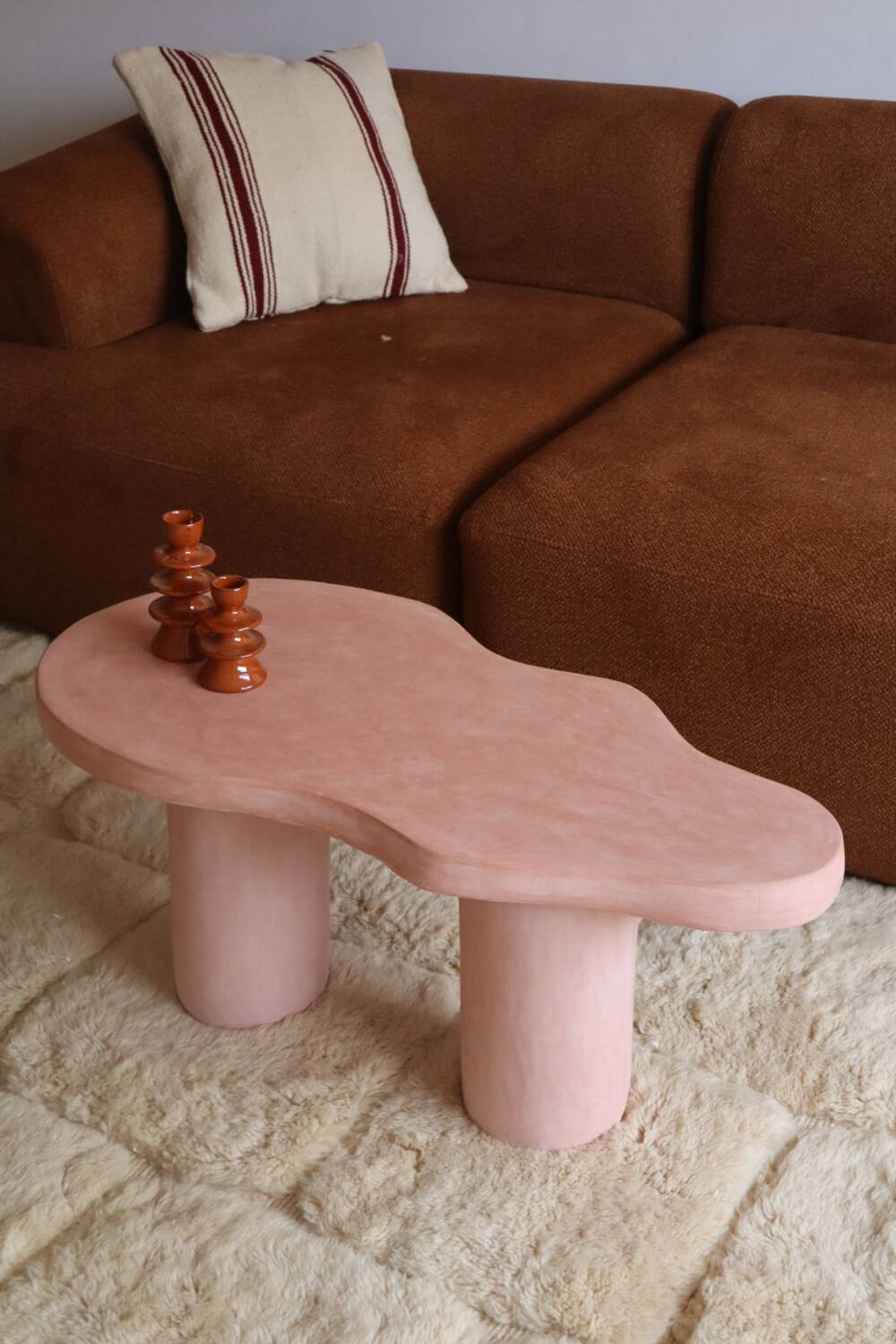 Organic shaped coffee table in pink teracotta tadelakt