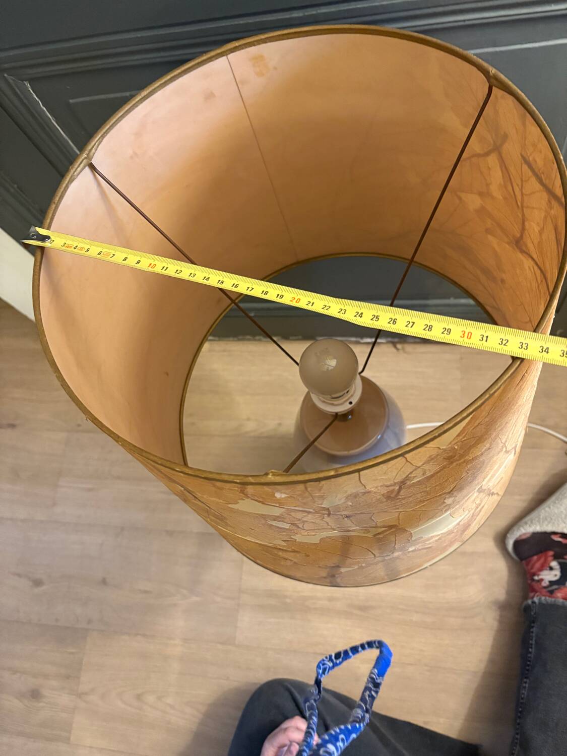 Large beige ceramic table lamp with a vintage shade.