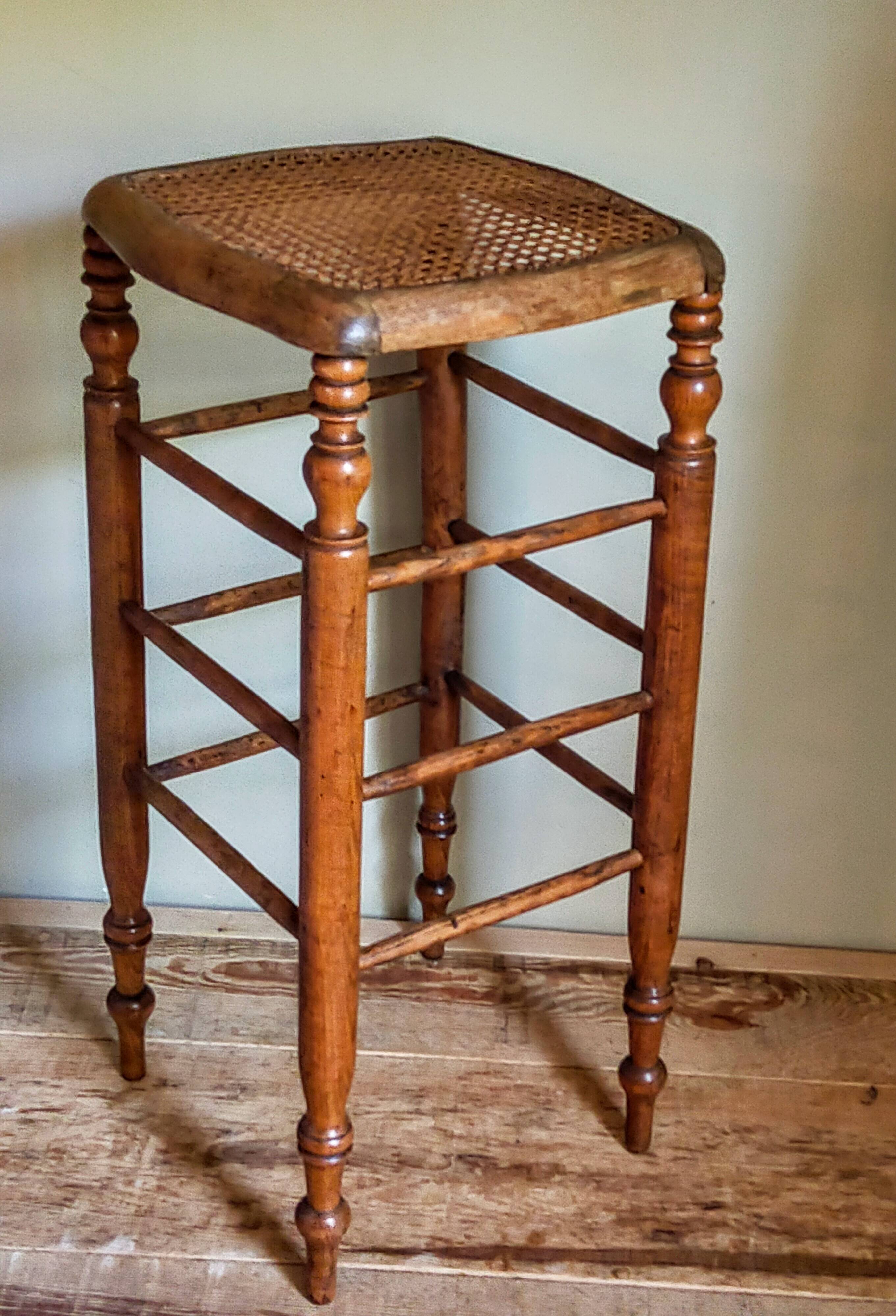 Antique stool with cane and turned wood