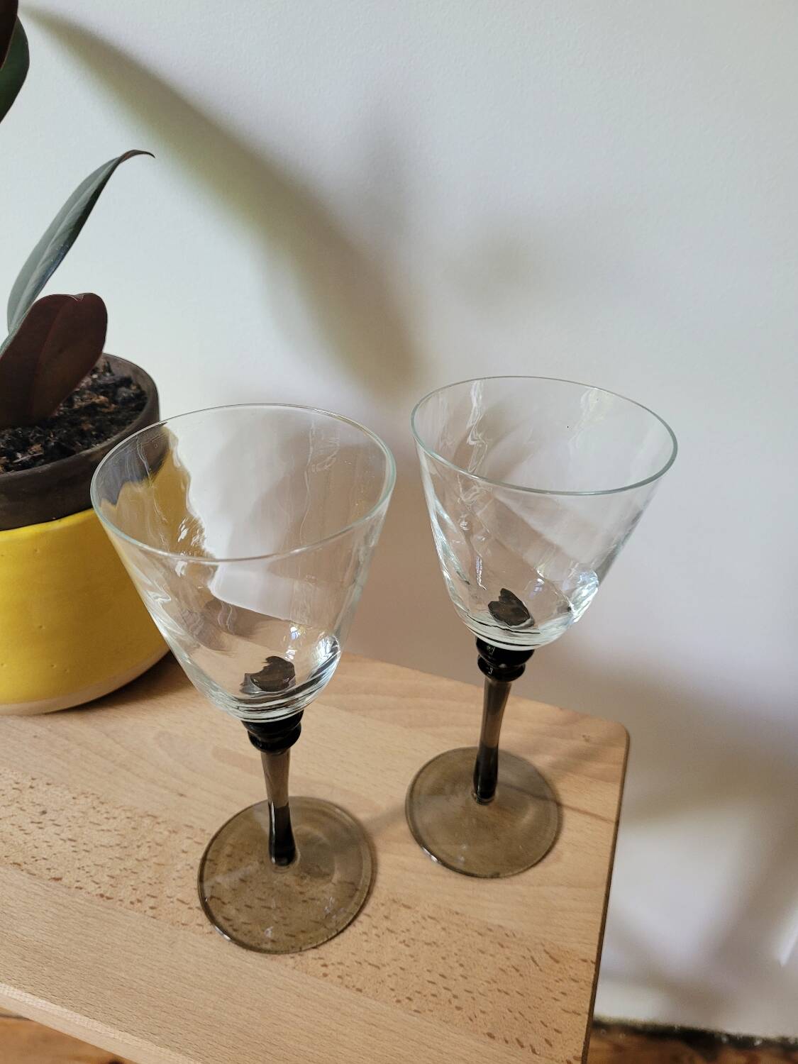 Two smoked black stem wine glasses