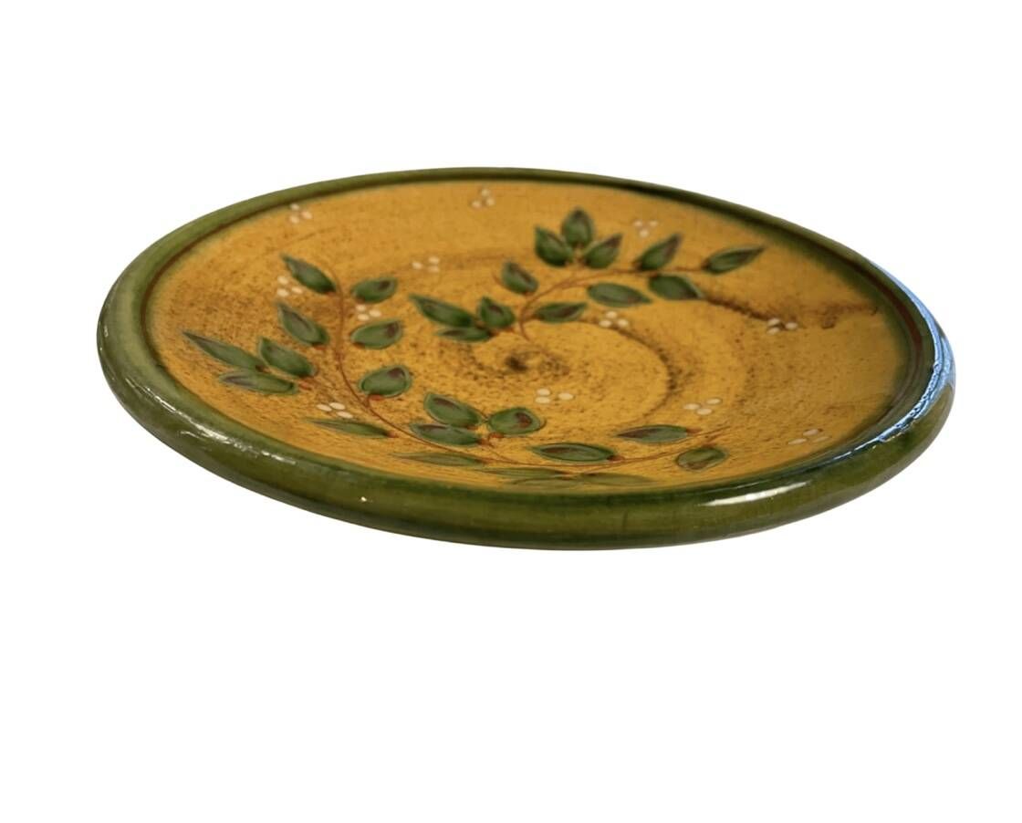 Decorative glazed terracotta plate with olive leaf pattern.