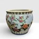 Antique porcelain vase with floral and bird decoration.
