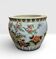 Antique porcelain vase with floral and bird decoration.