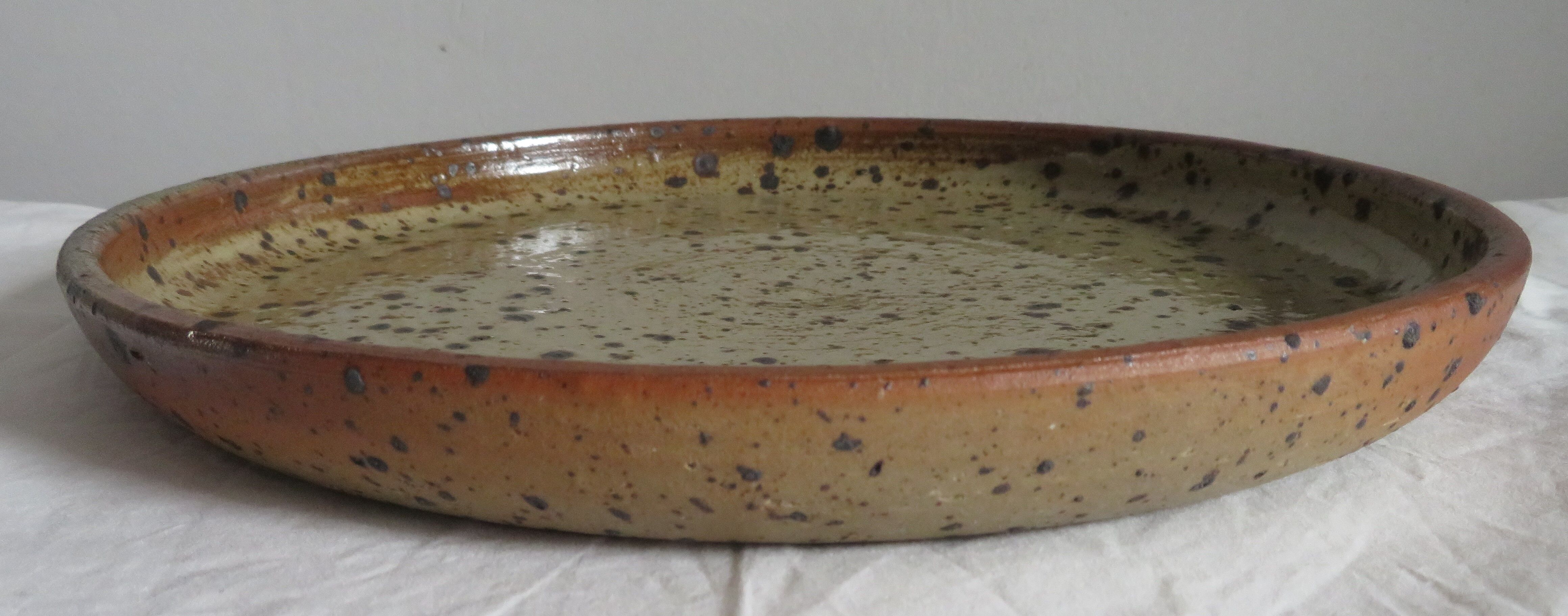 Round dish in varnished sandstone