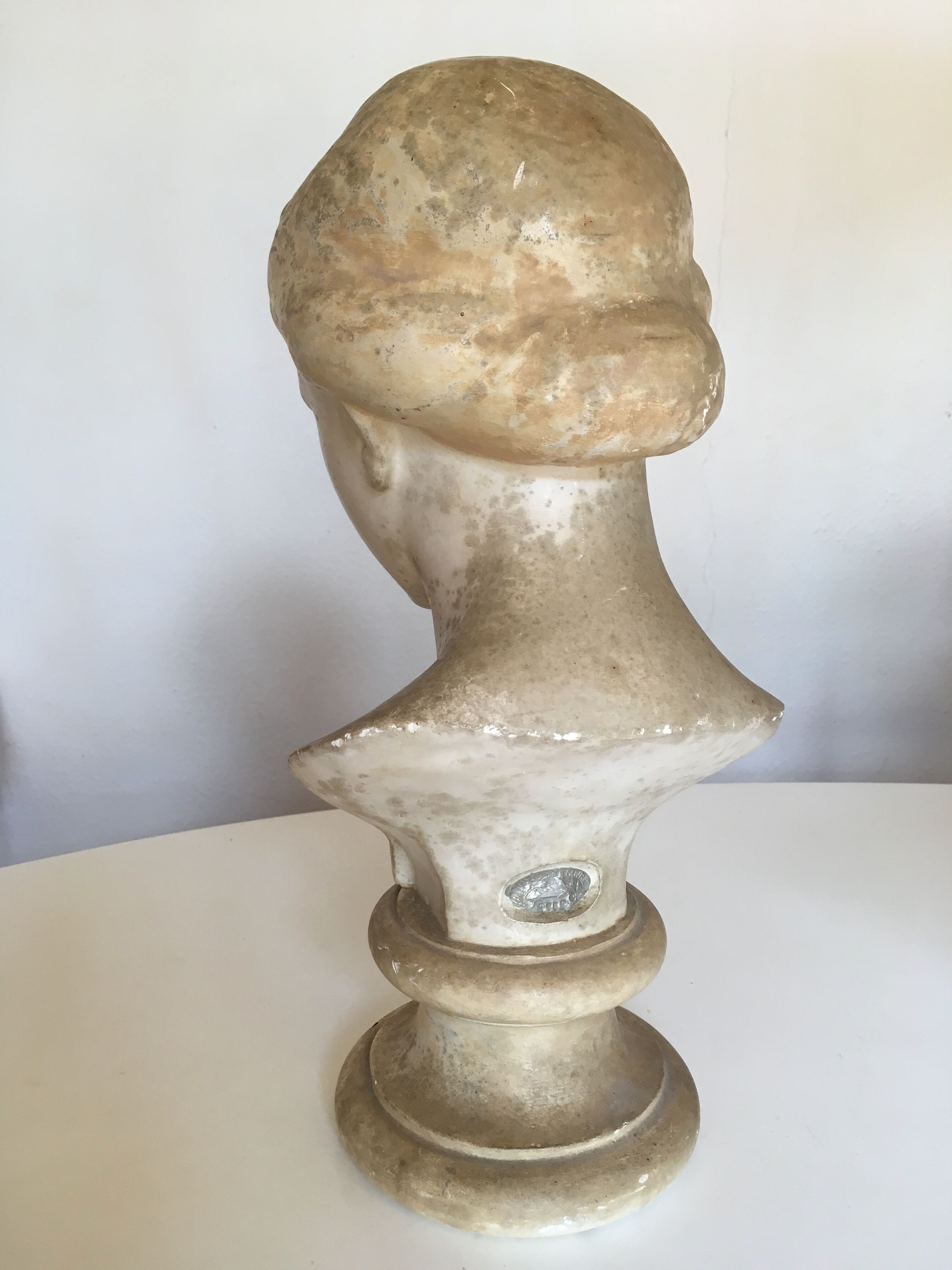 Former girl bust end 19th in plaster cast on its base
