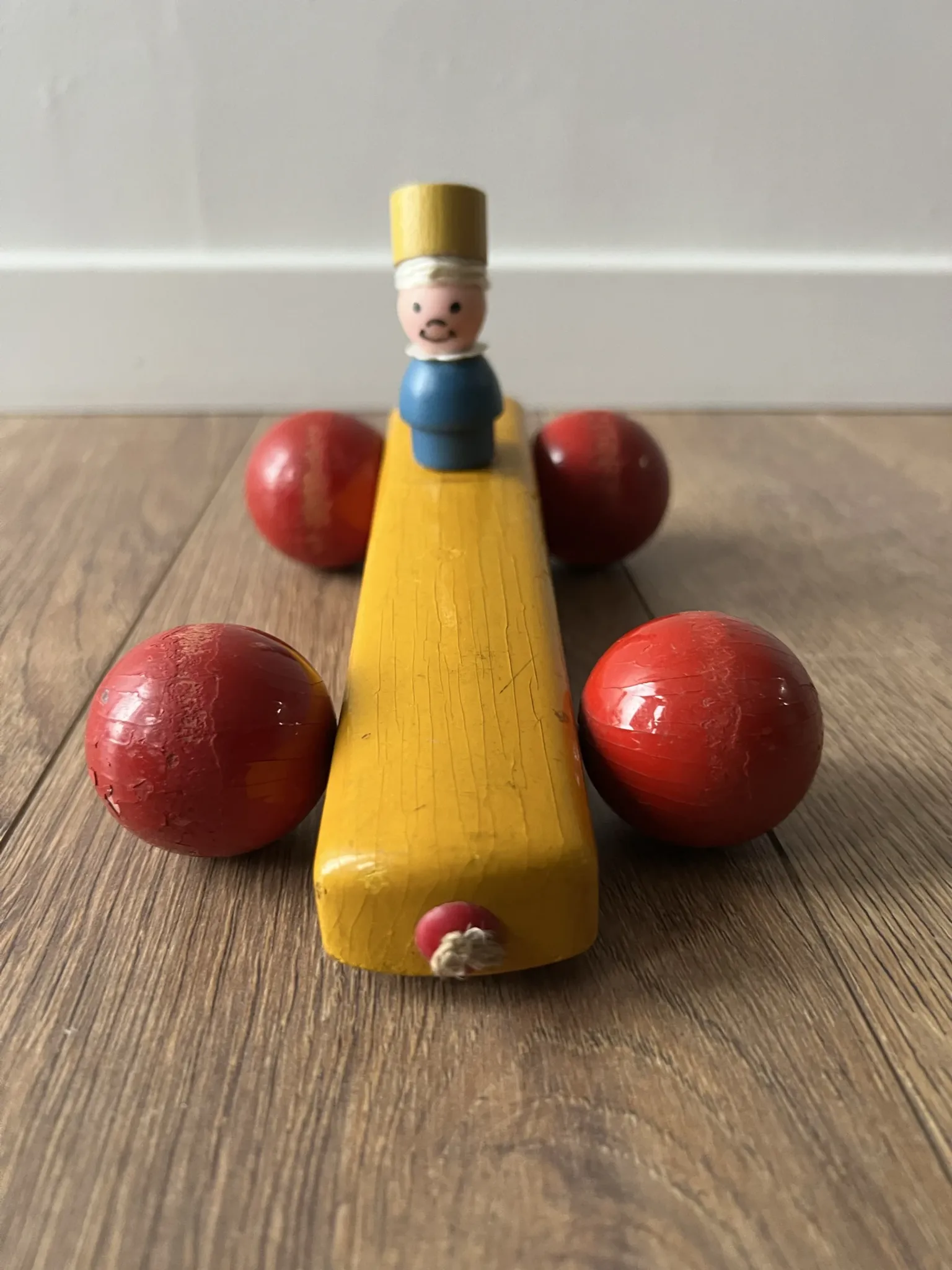 Vintage wooden pull toy, yellow car and small soldier.